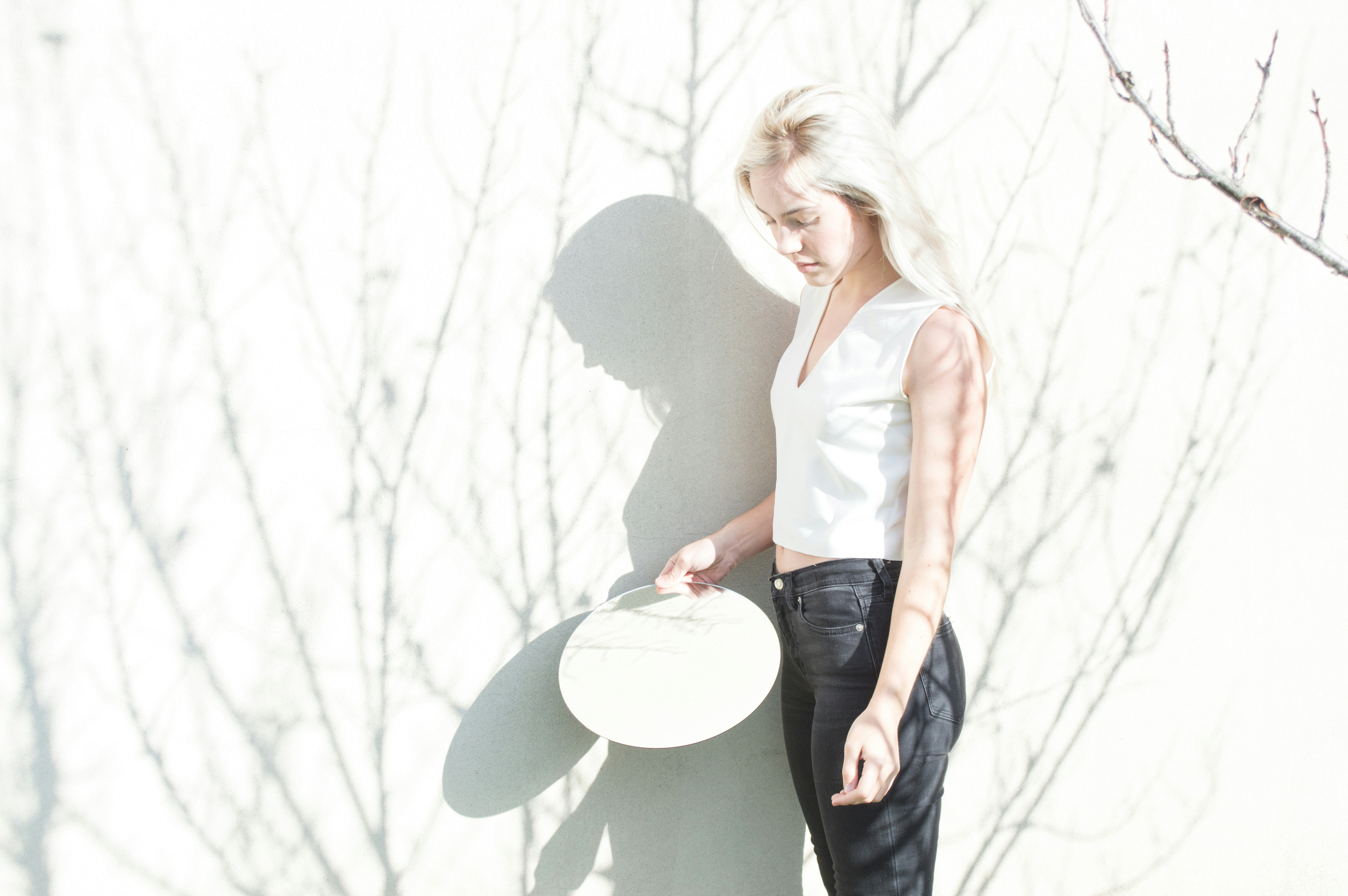 woman leaning on white board